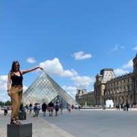 Student posing in front of the Louvre